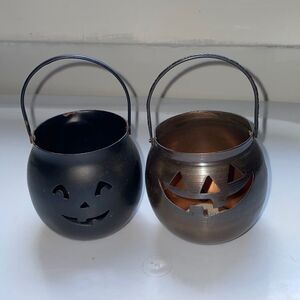 Two small metal Halloween Jack O Lantern votive candle holder
